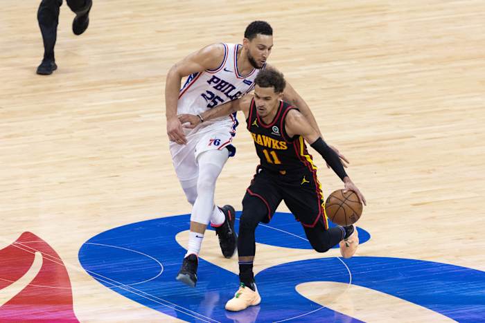 Atlanta Hawks guard Trae Young (11) dribbles past Philadelphia 76ers guard Ben Simmons (25) during the fourth quarter in game seven of the second round of the 2021 NBA Playoffs at Wells Fargo Center.